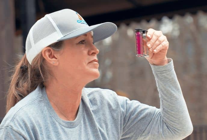 Woman testing the Ph of a pool