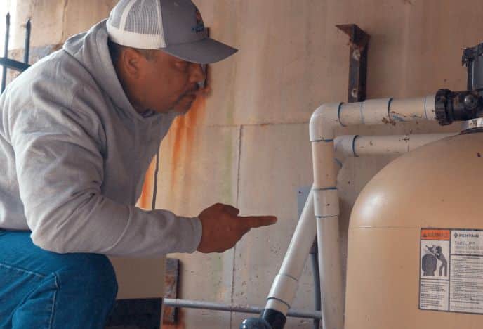 Man inspecting pool equipment