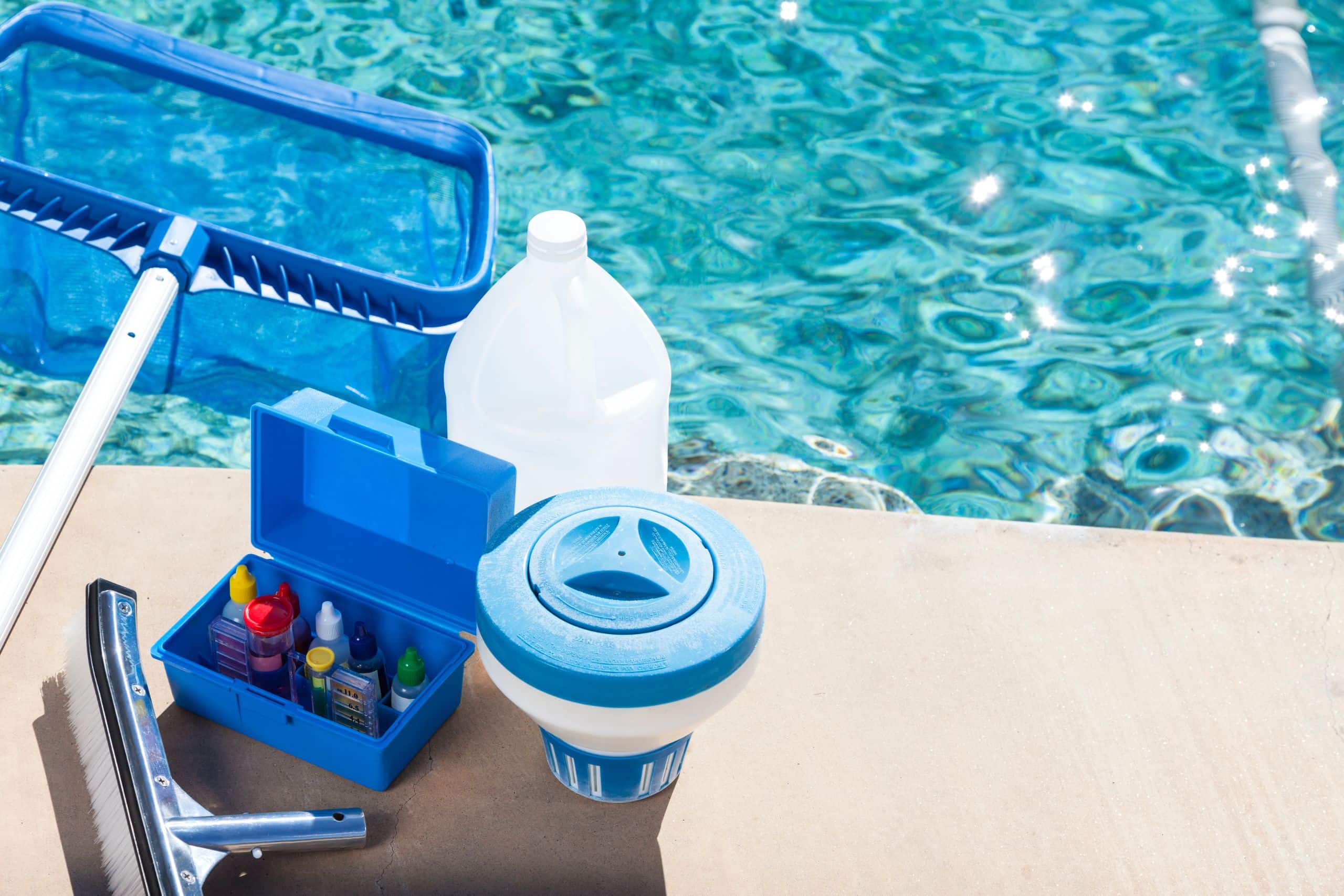 pool cleaning and maintenance supplies next to a pool